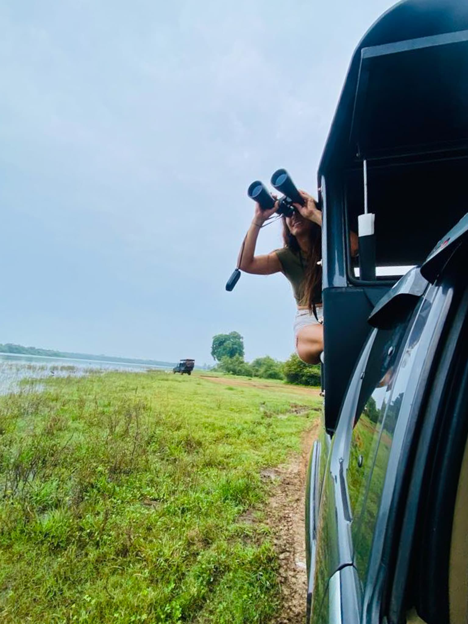 Wildlife photographer looking out from a safari jeep